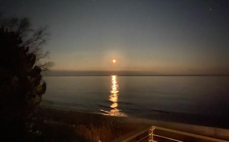 The full moon rising over Lake Huron from the dining porch